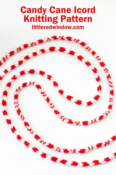 Red and white striped knitted candy cane icord, artfully curved on a white background. Text above reads, 