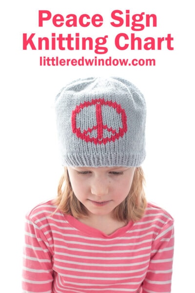 A young girl wearing a gray knitted hat with a red peace sign design looks down. She is dressed in a pink and white striped shirt. Text above reads: