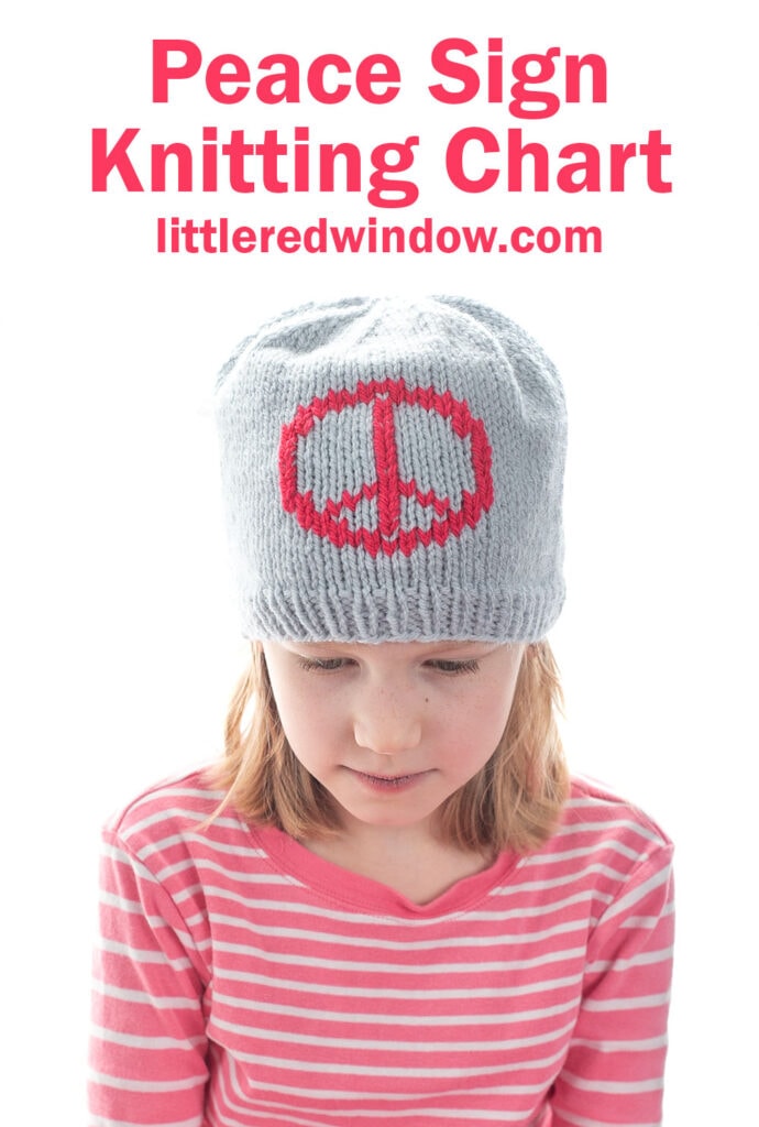 A young girl wearing a gray knitted hat with a red peace sign design looks down. She is dressed in a pink and white striped shirt. Text above reads: