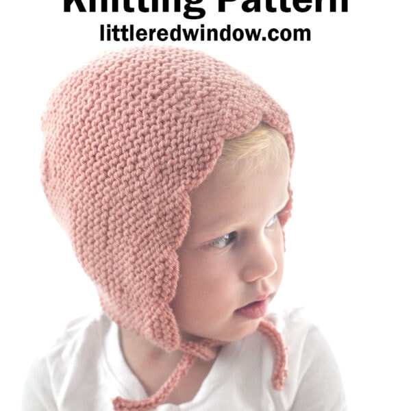 A young child wears a delicate, pink scalloped bonnet knitted in garter stitch. The text above reads: