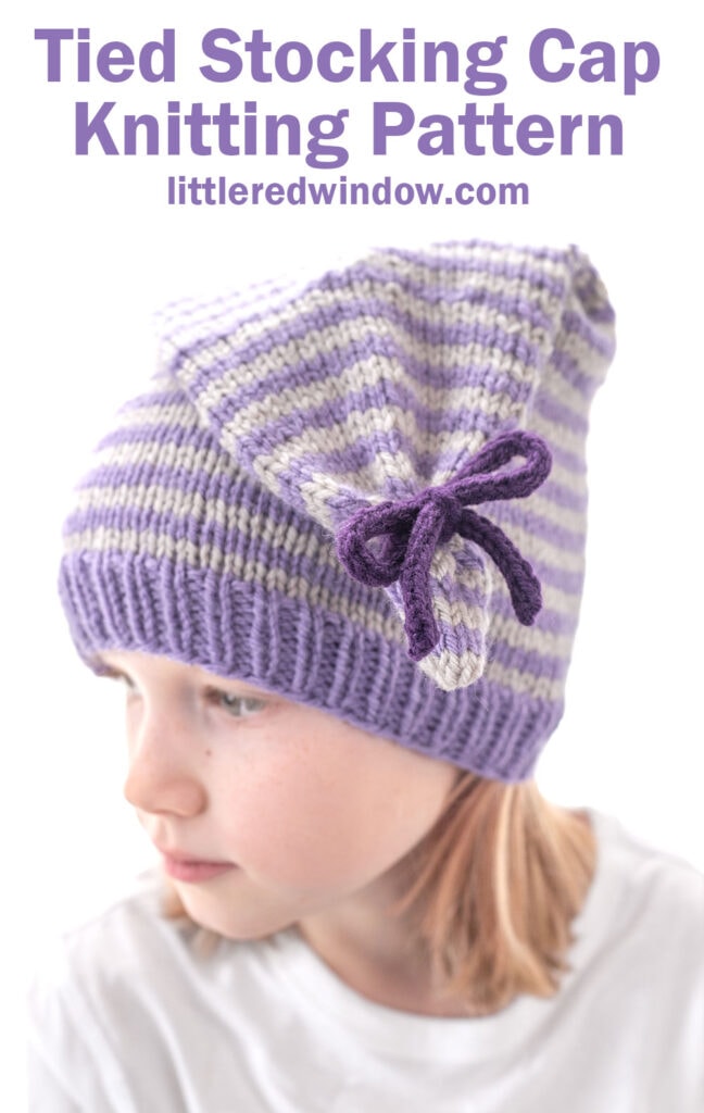 A child wears a purple and white striped tied stocking cap with a bow on the side. Text above reads: