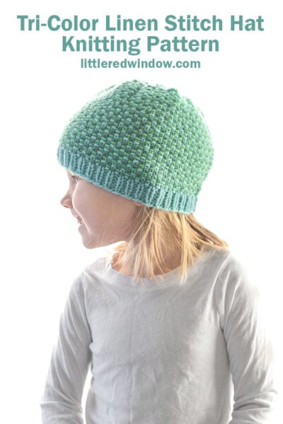 A young child wearing a blue and green linen stitch hat looks to the side. The image promotes a